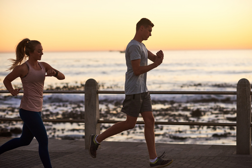 couple running with smartwatches