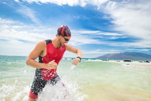 man checking smartwatch after swimming