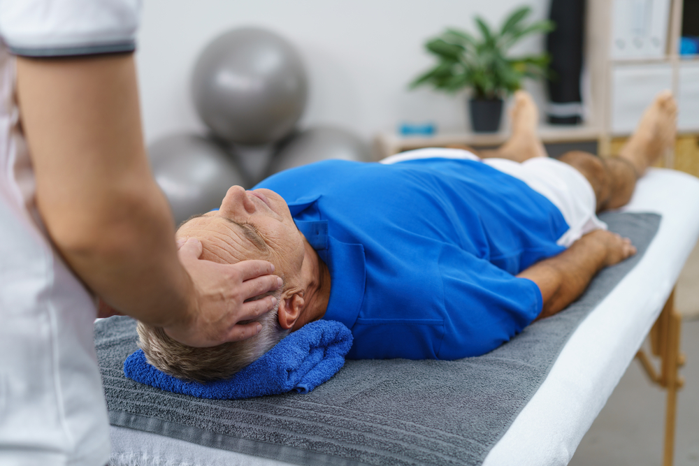 Physical Therapist assisting patient with headache