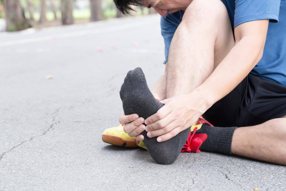 Runner holding foot from Plantar Fasciitis