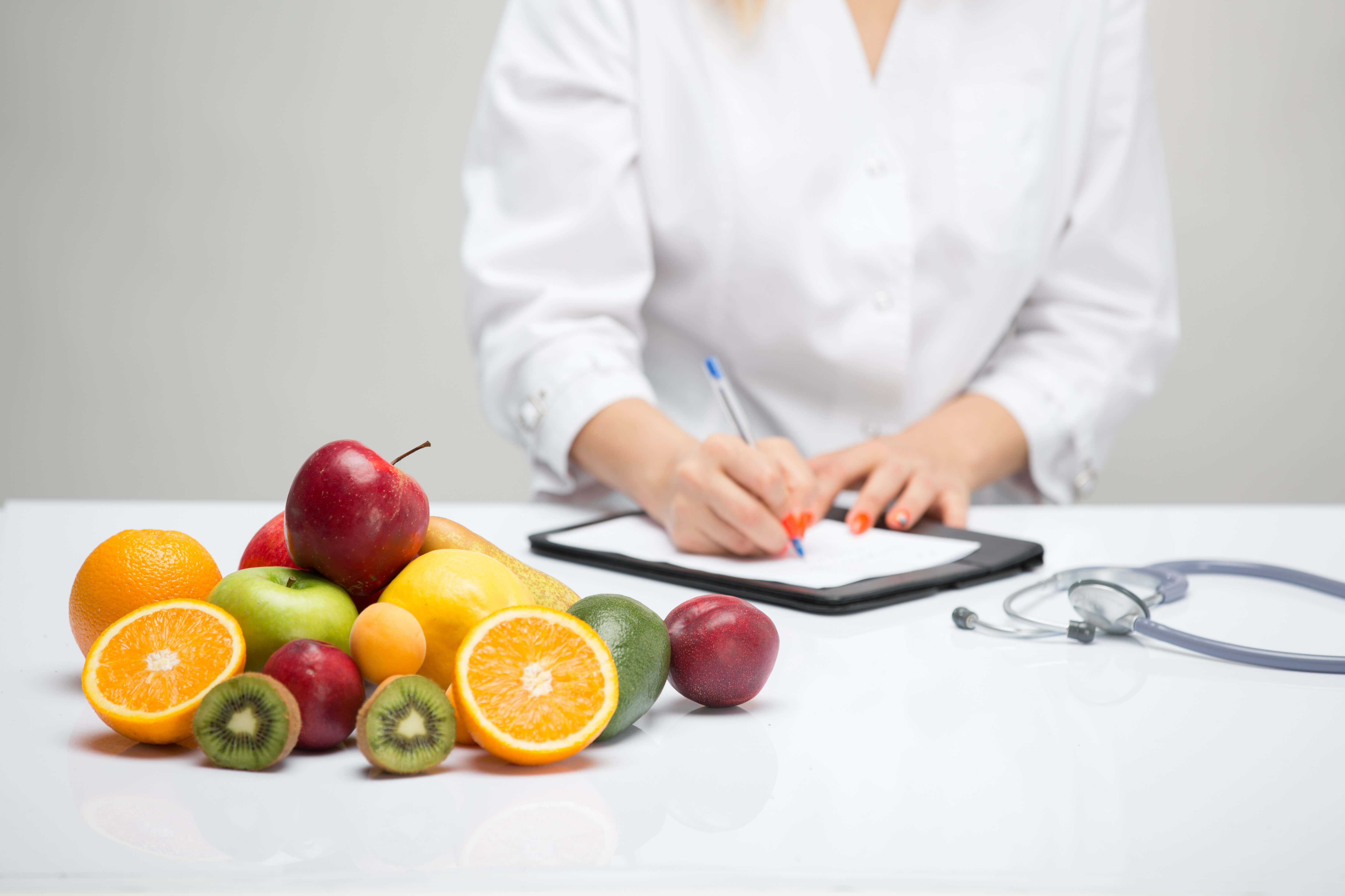 Healthy life style concept, doctor writing, diet and losing weight