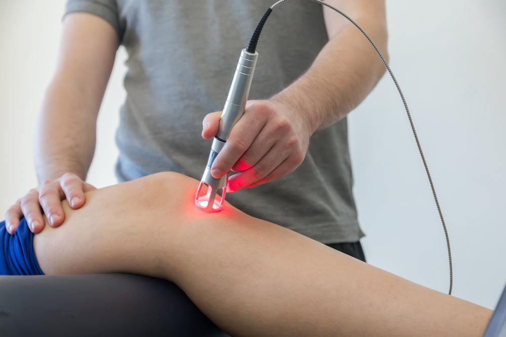 Laser therapy on a knee used to treat pain